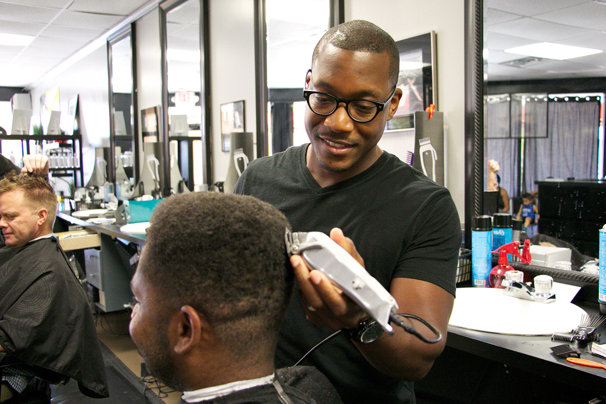 Chris Tyson, a partner in Chris Tyson Grooming Co., 6939 S. Lewis Ave., cuts hair Friday morning. DYLAN GOFORTH/The Frontier