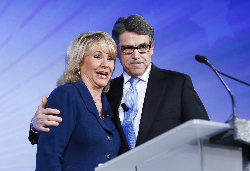  Gov. Mary Fallin, left, and former Texas Gov. Rick Perry, right, stand together at the Southern Republican Leadership Conference in Oklahoma City in May.   ALONZO ADAMS / AP