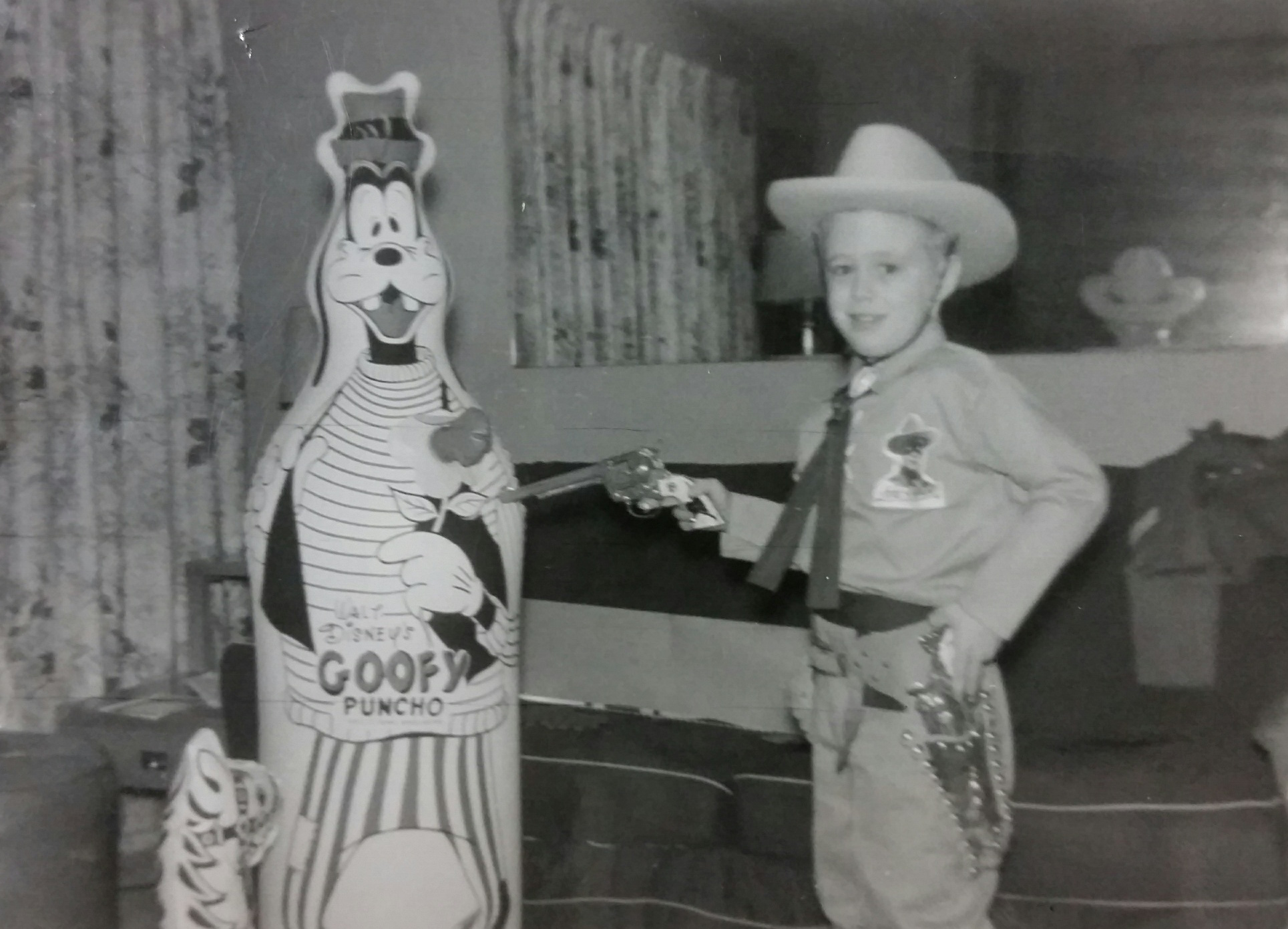 A young Terry Simonson, dressed as a sheriff, takes aim at Goofy in his home in Gary, Ind. Courtesty
