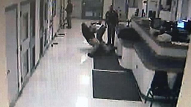 This photo taken from the security camera video shows a deputy in the Cherokee County Jail holding down Daniel Bosh, who is handcuffed.  Photo courtesy KOTV