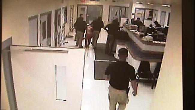 Jailers drag Daniel Bosh out of the shower area after he was beaten in the Cherokee County Jail.  Photo courtesy KOTV